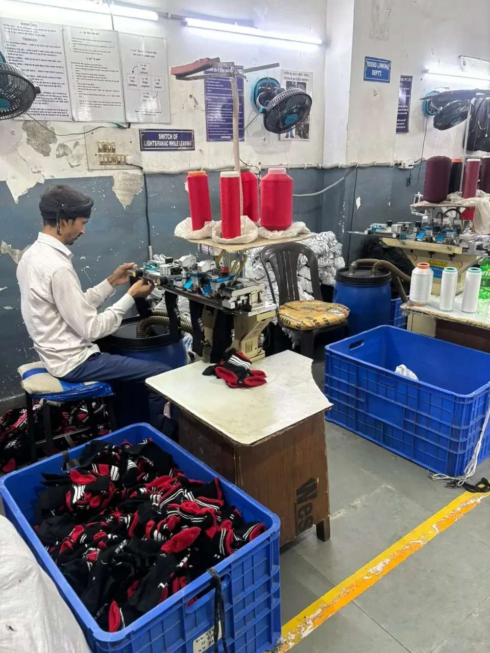 Team operating sock linking equipment on the production floor