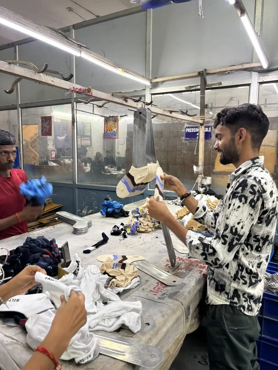 Socks positioned on forms during the pressing stage