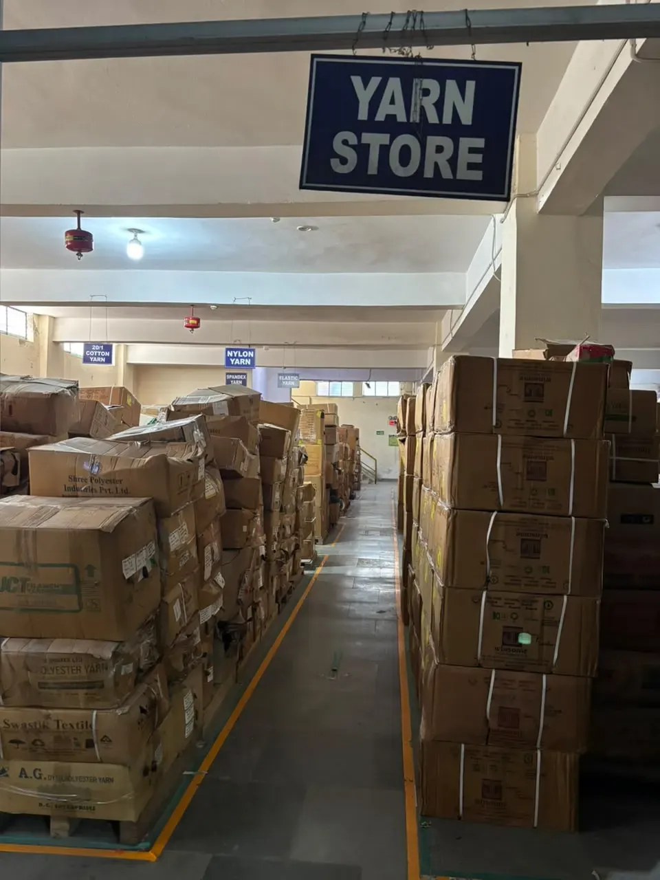 Yarn store with labelled sections and marked aisles